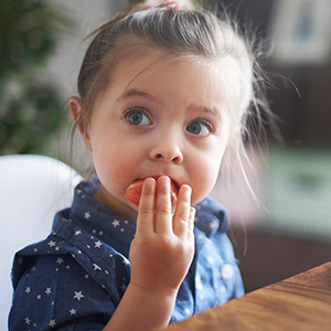 girl eating tomato girl eating tomato
